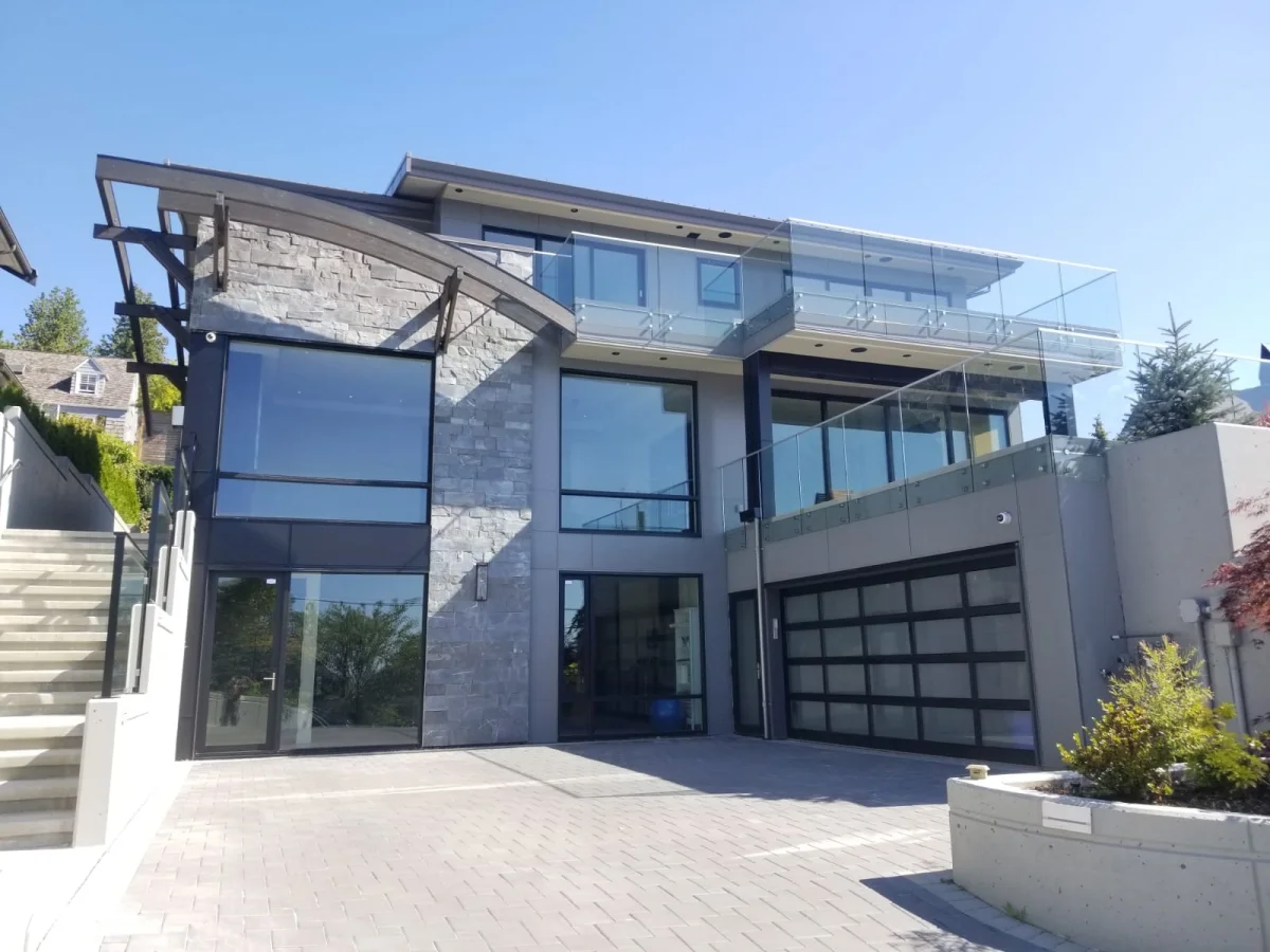 Stone veneer, aluminum windows, and glass railings on luxury home in West Vancouver